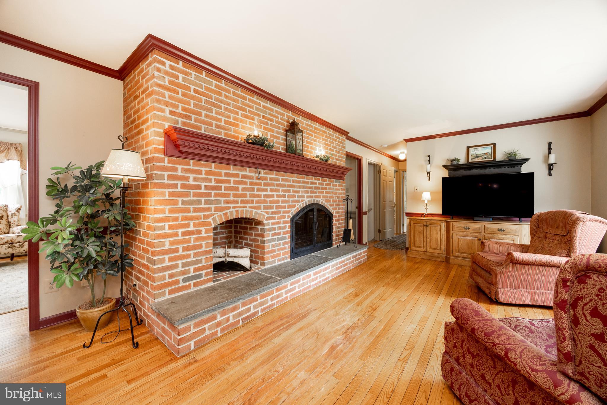 741 Cowpath Road Telford, PA 18969 - Photo 17 of 72 a living room with furniture a fireplace and a flat screen tv