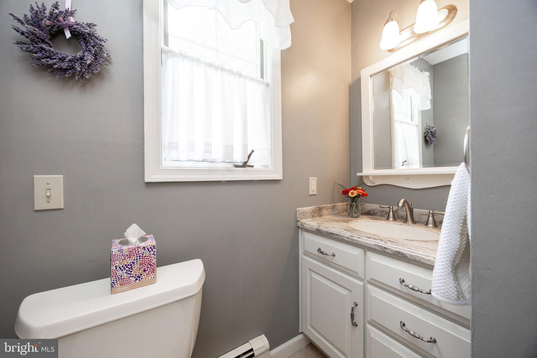 741 Cowpath Road Telford, PA 18969 - Photo 28 of 72 a bathroom with a granite countertop toilet sink mirror and vanity