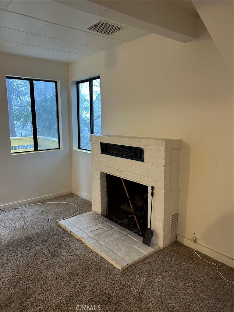 614 Arrowhead Villa Road Lake Arrowhead, CA 92352 - Photo 5 of 9 a view of empty room with a fireplace