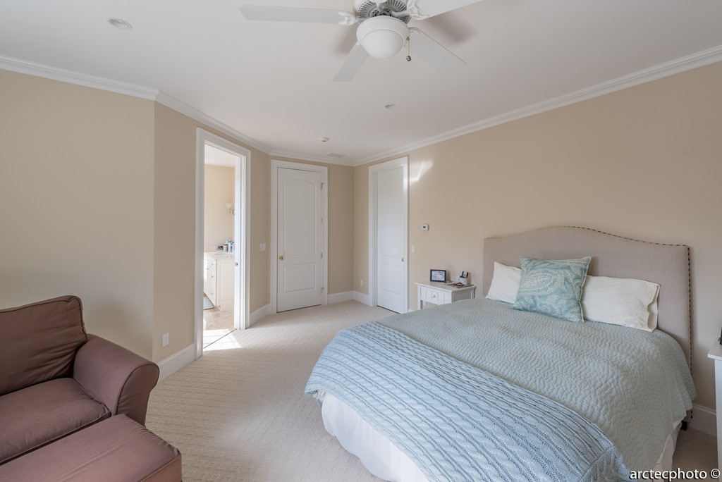 44 Pleasant Park Drive Mashpee, MA 02649 - Photo 12 of 14 a spacious bedroom with a bed and a chandelier