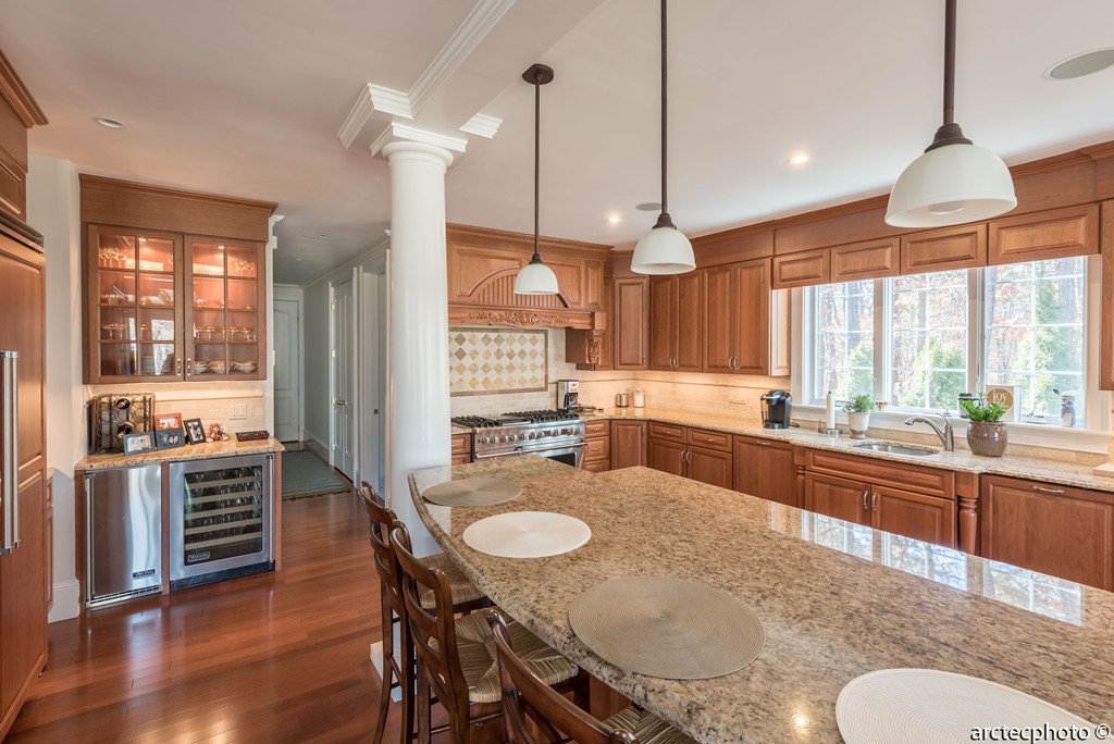 44 Pleasant Park Drive Mashpee, MA 02649 - Photo 3 of 14 a kitchen with stainless steel appliances granite countertop a stove a kitchen island a table and chairs
