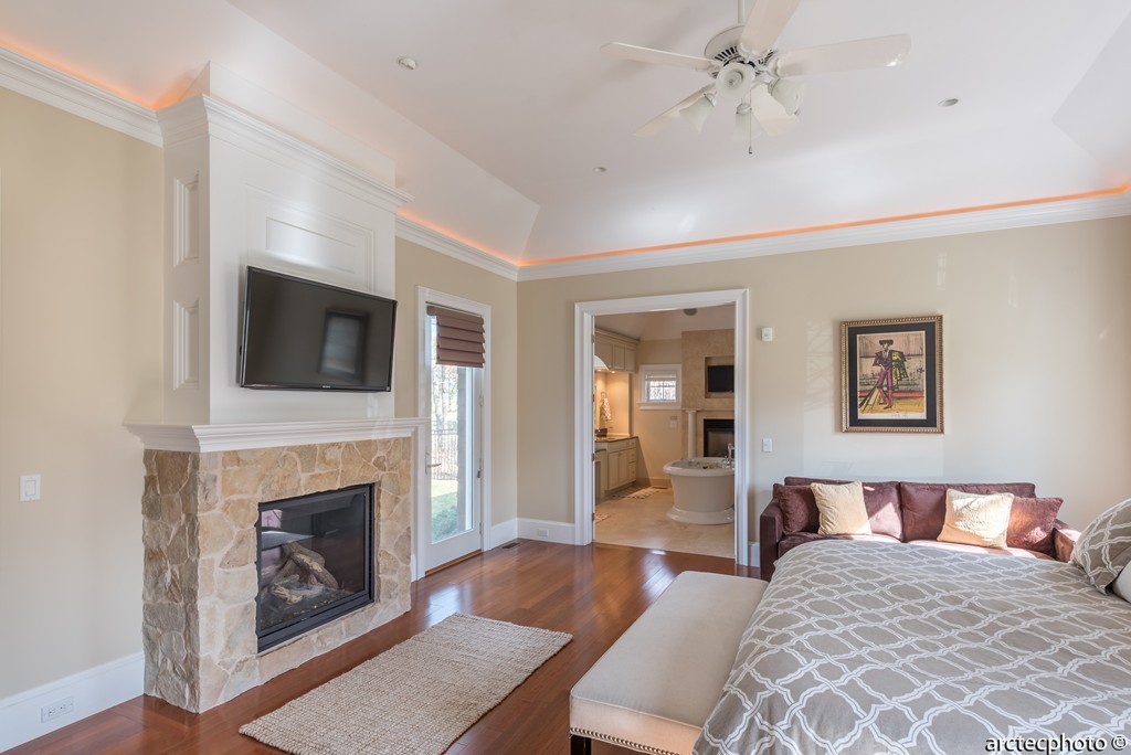 44 Pleasant Park Drive Mashpee, MA 02649 - Photo 8 of 14 a spacious bedroom with a bed and a fireplace