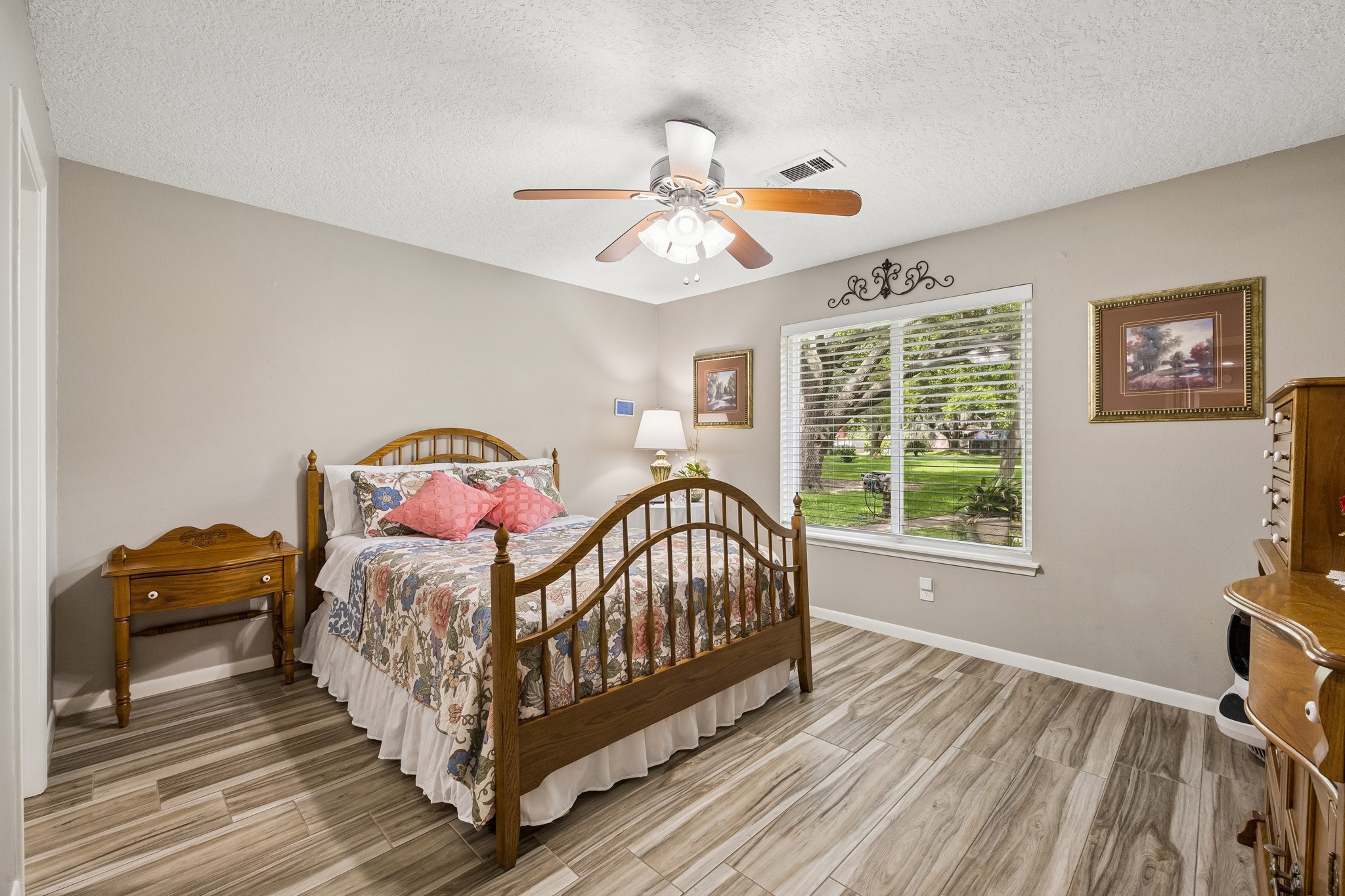 2102 Casa Rio Circle Dickinson, TX 77539 - Photo 11 of 22 Spacious primary bedroom tucked away at the back of the home, offering a peaceful retreat with views of the beautifully maintained courtyard. With no rear neighbors, this room enjoys added privacy and a tranquil setting rarely found in a condominium community. ***Bonus ~ Large picture window***