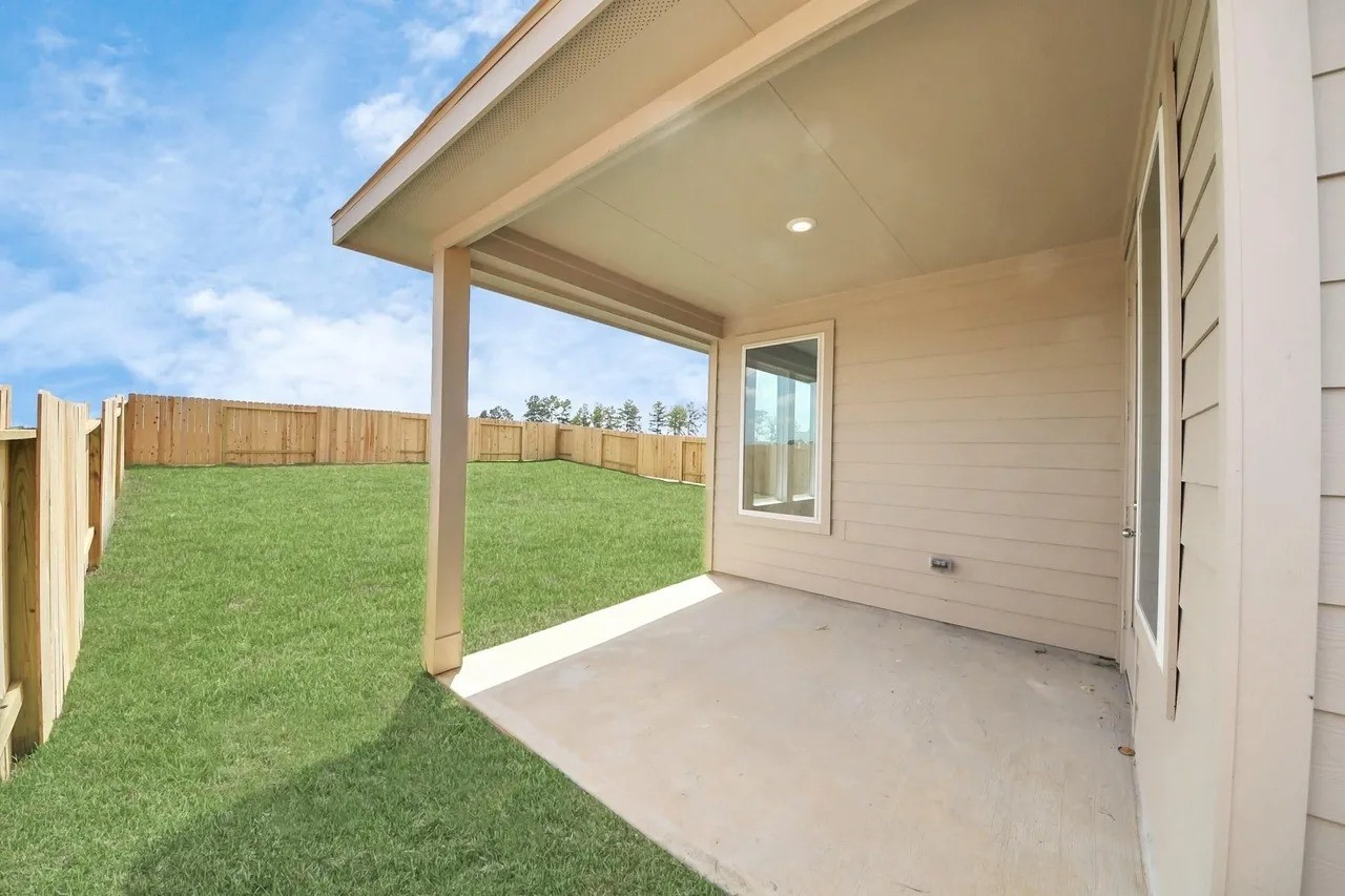 14439 Trumpet Lane Splendora, TX 77372 - Photo 14 of 15 a view of an empty room with yard and a floor to ceiling window