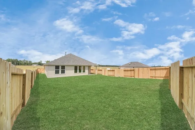 a view of a house with yard and a garden