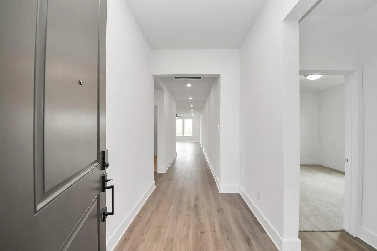 14439 Trumpet Lane Splendora, TX 77372 - Photo 3 of 15 a view of a hallway with wooden floor