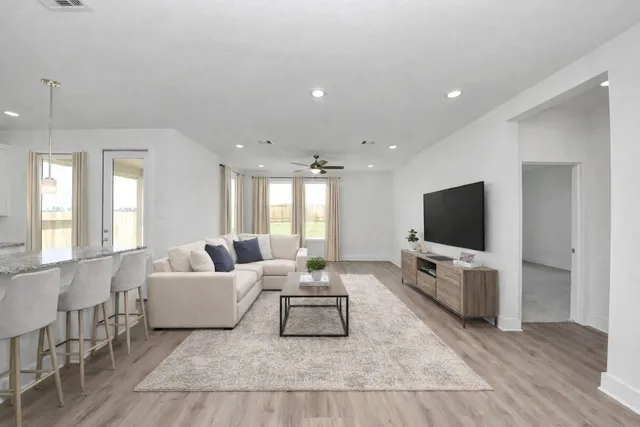 a living room with furniture and a flat screen tv