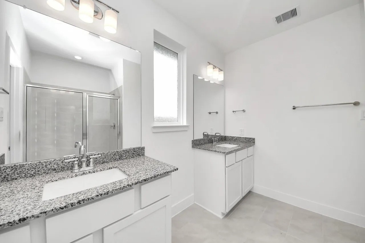 14439 Trumpet Lane Splendora, TX 77372 - Photo 7 of 15 a bathroom with a granite countertop sink and a mirror