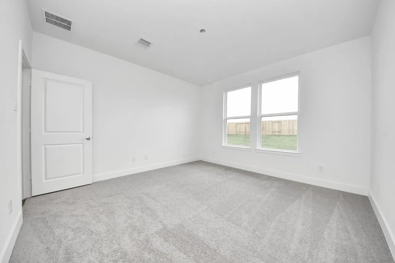 14439 Trumpet Lane Splendora, TX 77372 - Photo 10 of 15 an empty room with windows
