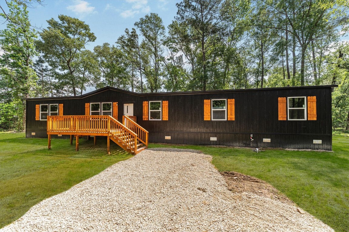 16465 Hickory Road Conroe, TX 77302 - Photo 2 of 42 a front view of a house with garden