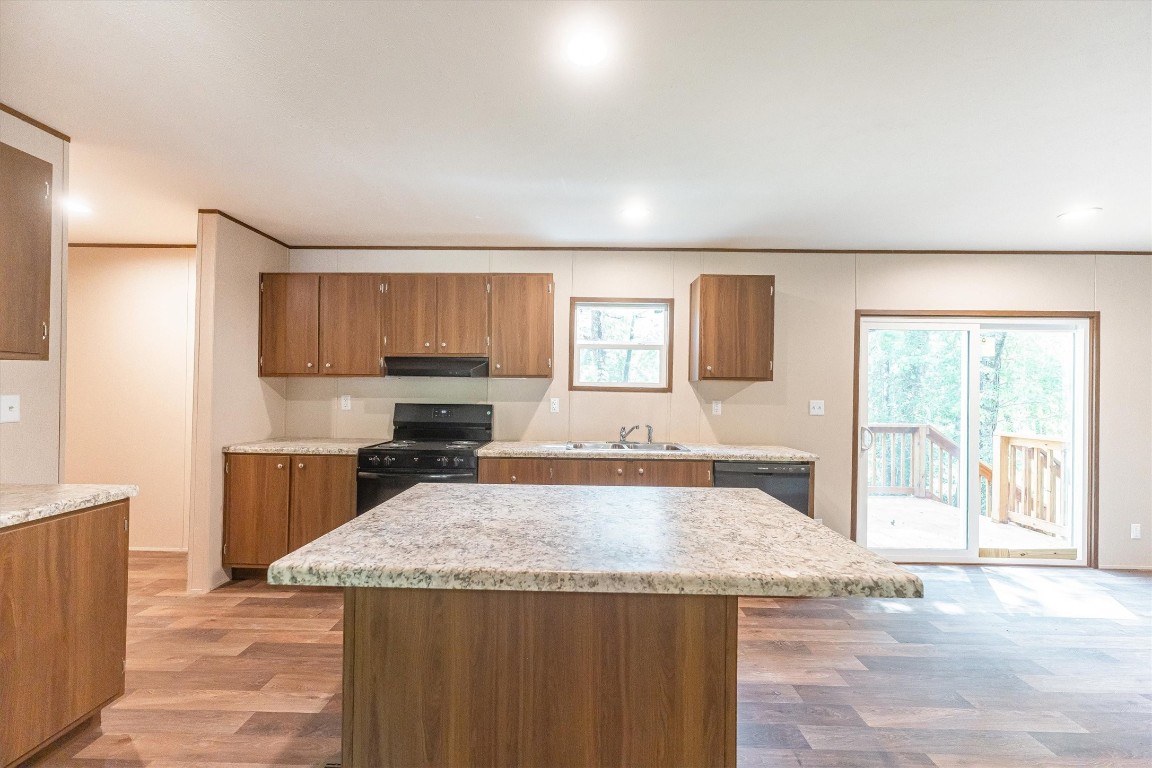 16465 Hickory Road Conroe, TX 77302 - Photo 24 of 42 a kitchen with granite countertop a stove and a sink