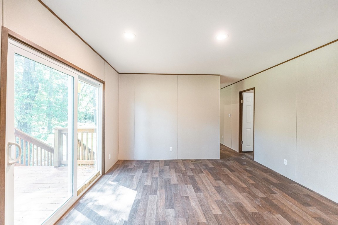 16465 Hickory Road Conroe, TX 77302 - Photo 27 of 42 an empty room with wooden floor and windows