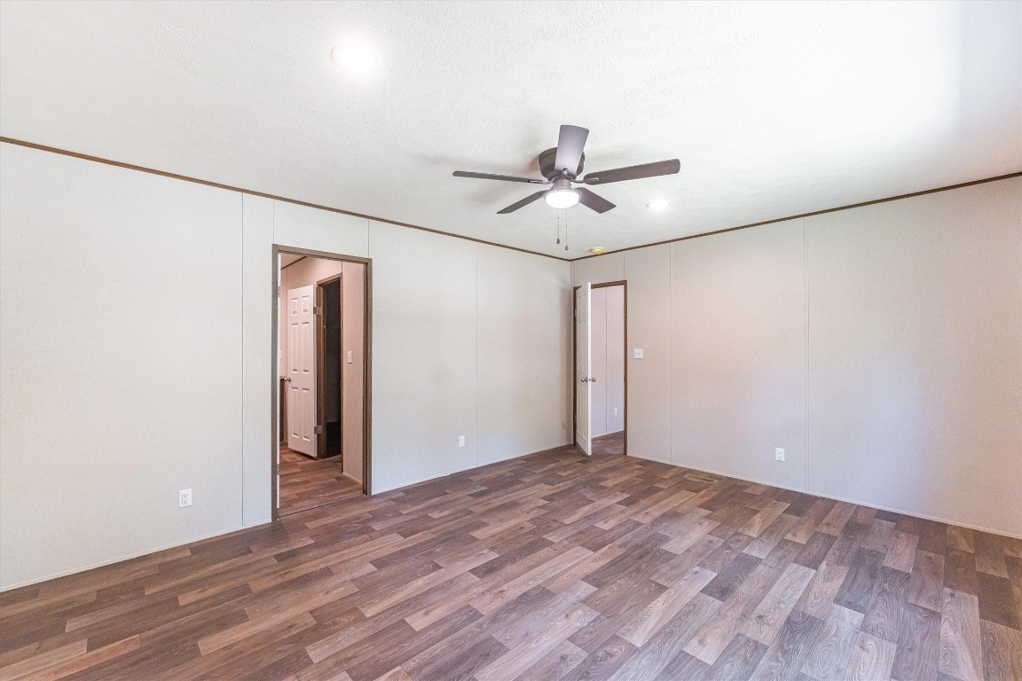 16465 Hickory Road Conroe, TX 77302 - Photo 32 of 42 a view of a big room with wooden floor and a ceiling fan in a room