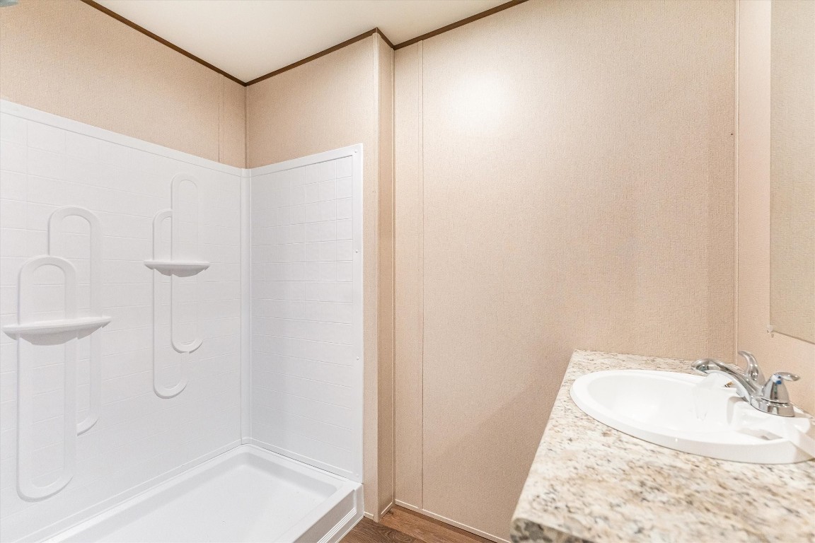 16465 Hickory Road Conroe, TX 77302 - Photo 39 of 42 a bathroom with a granite countertop sink and a mirror