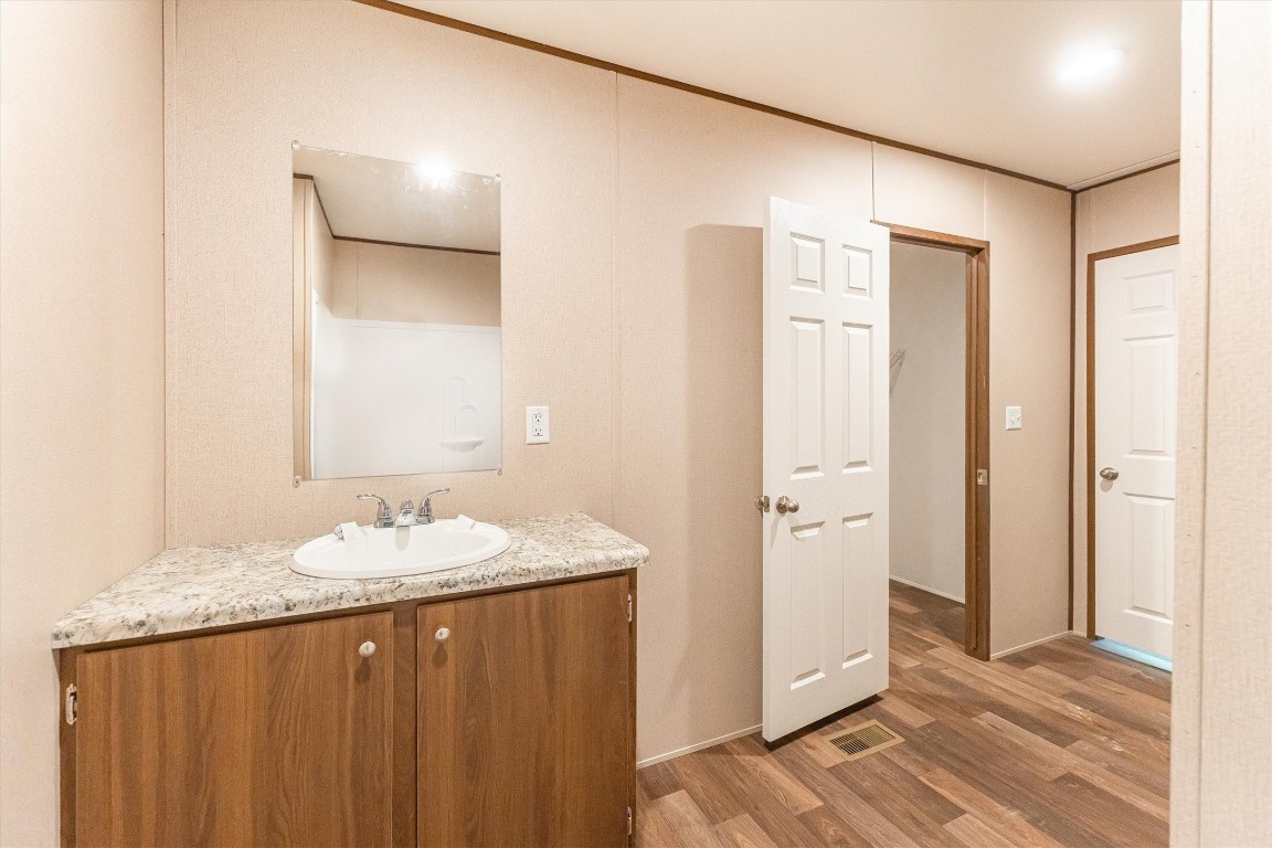 16465 Hickory Road Conroe, TX 77302 - Photo 40 of 42 a bathroom with a granite countertop sink and a mirror