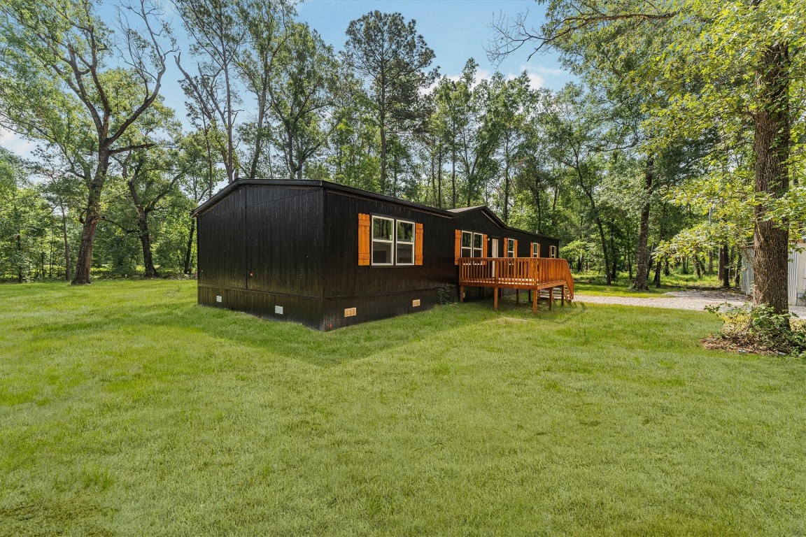16465 Hickory Road Conroe, TX 77302 - Photo 4 of 42 a view of a house with a yard