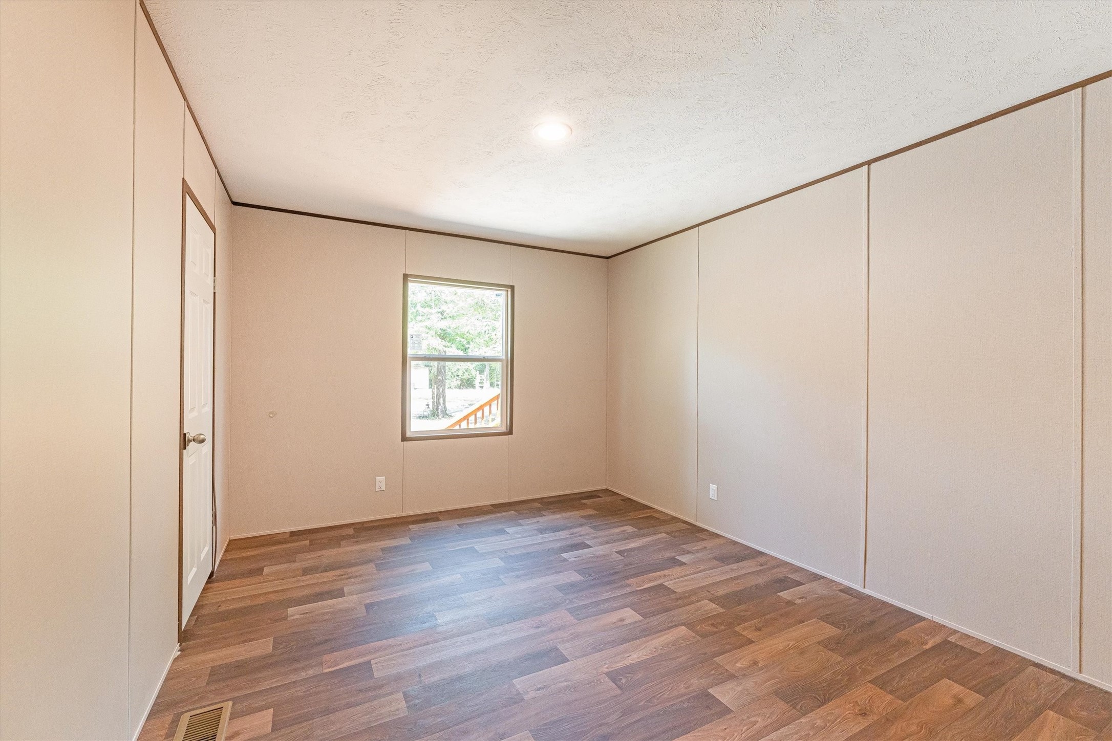 16465 Hickory Road Conroe, TX 77302 - Photo 41 of 42 an empty room with wooden floor and windows