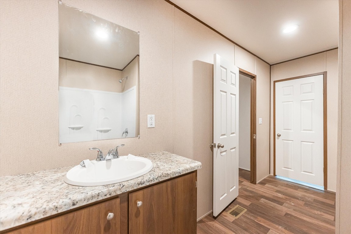 16465 Hickory Road Conroe, TX 77302 - Photo 42 of 42 a bathroom with a granite countertop sink and a mirror
