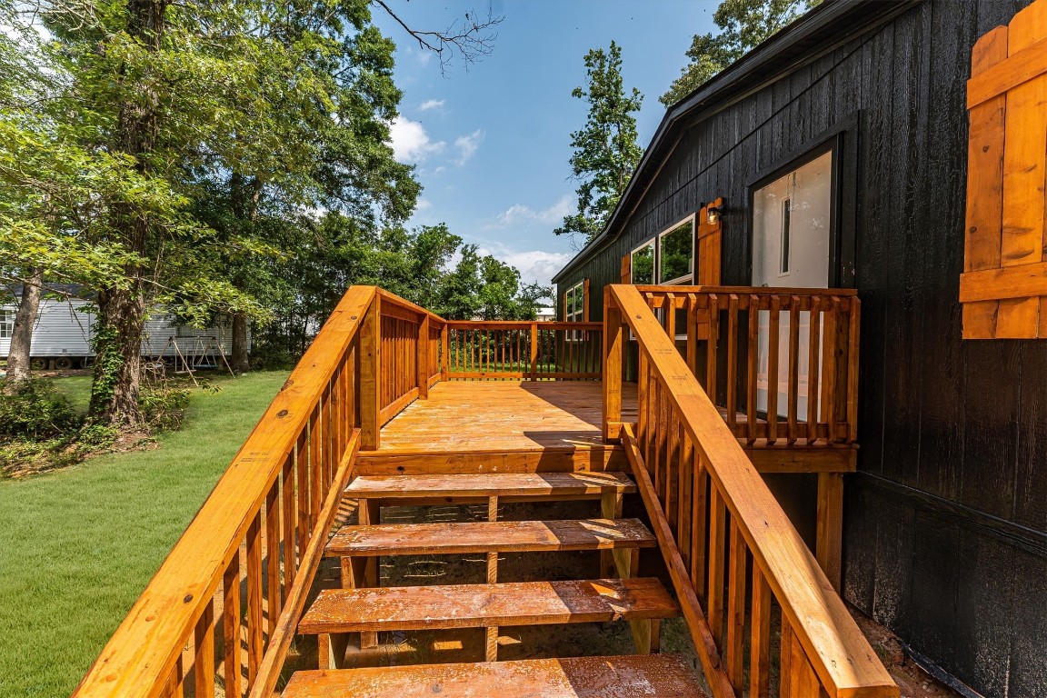 16465 Hickory Road Conroe, TX 77302 - Photo 6 of 42 a view of balcony with wooden floor and fence and a trees