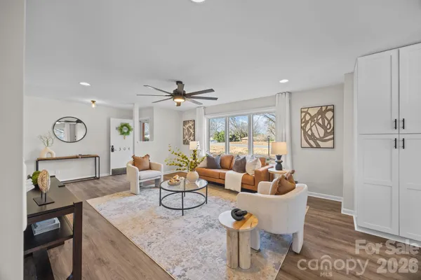a living room with furniture and a wooden floor
