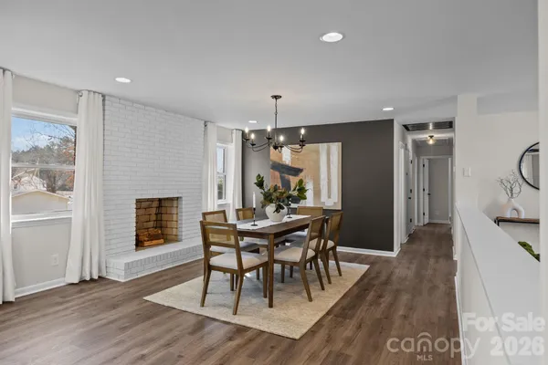 a view of a dining room with furniture and wooden floor
