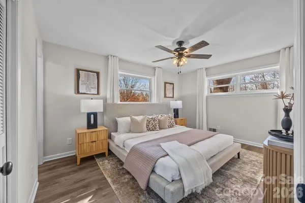 a bedroom with a bed a window and dresser