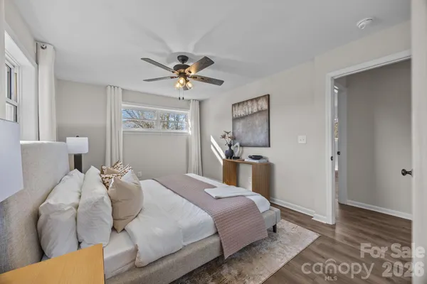 a bedroom with a bed and a painting on the wall