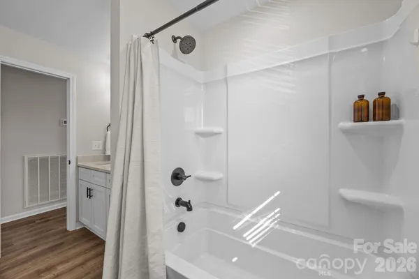 a spacious bathroom with a double vanity sink and a mirror