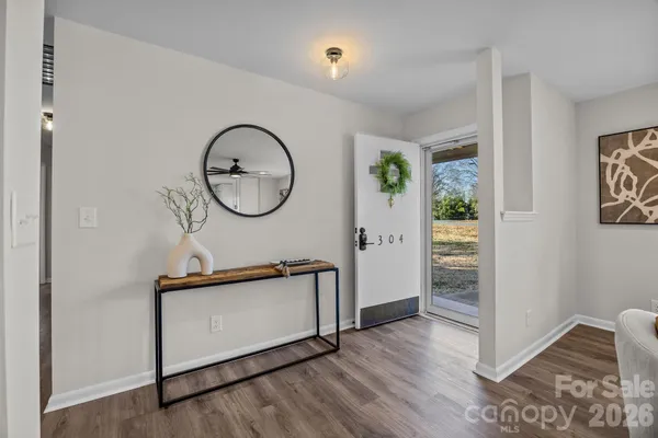 a view of living room filled with furniture and wooden floor