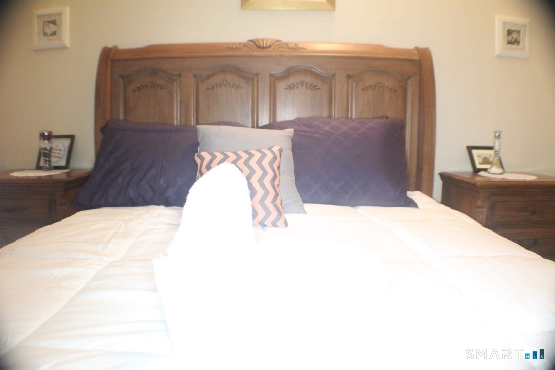 150 Whitney Street Hartford, CT 06105 - Photo 23 of 39 a bed sitting in a bedroom and wooden floor