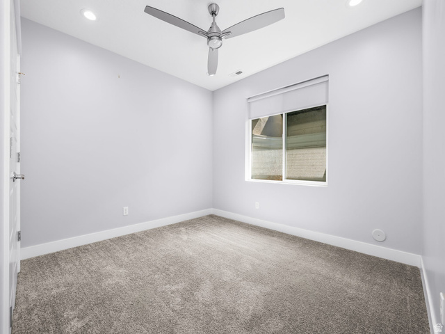 877 South Yarrow Drive Mapleton, UT 84664 - Photo 22 of 46 Room featuring recessed lighting, a modern ceiling fan, a window with roller shade, neutral wall tones, and gray carpet flooring