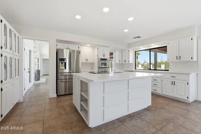 a kitchen with white cabinets