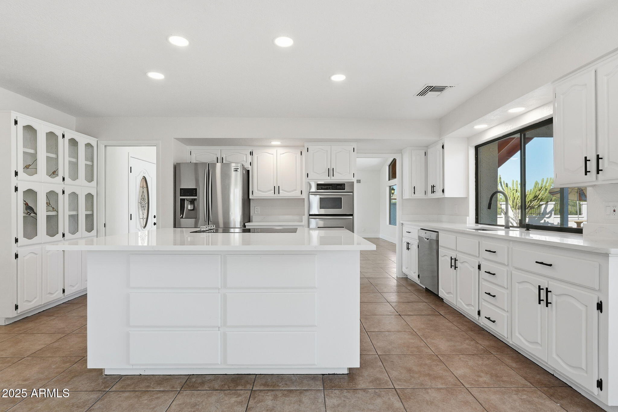 5810 East 14th Avenue Apache Junction, AZ 85119 - Photo 16 of 38 a large white kitchen with cabinets