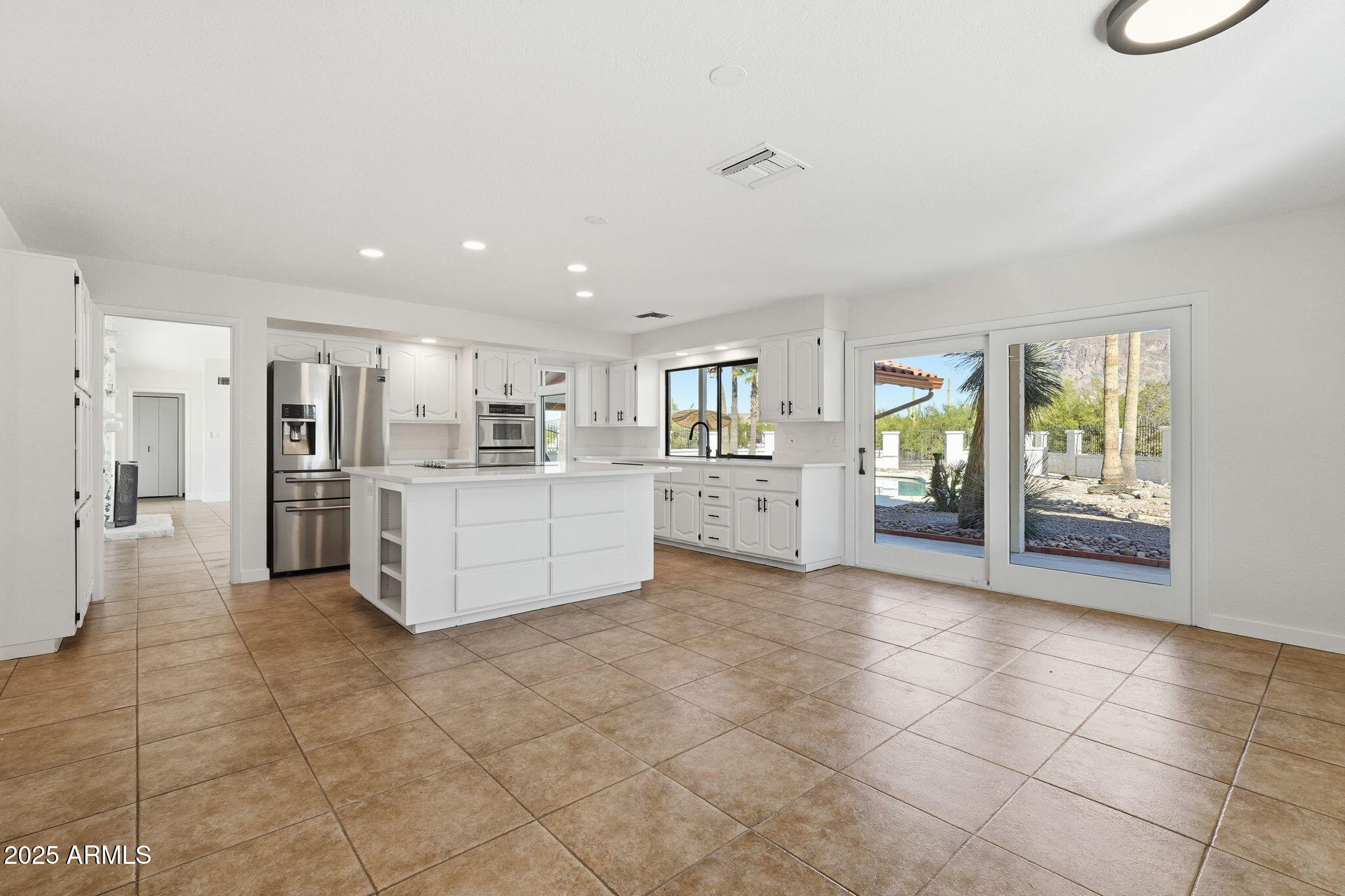 5810 East 14th Avenue Apache Junction, AZ 85119 - Photo 18 of 38 a large white kitchen with a stove a refrigerator and a sink