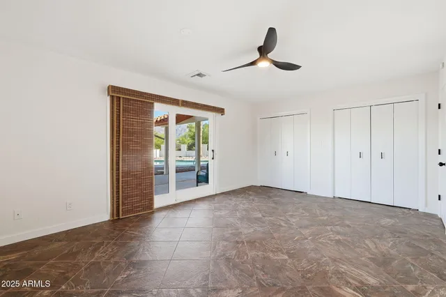 a view of an empty room with a ceiling fan