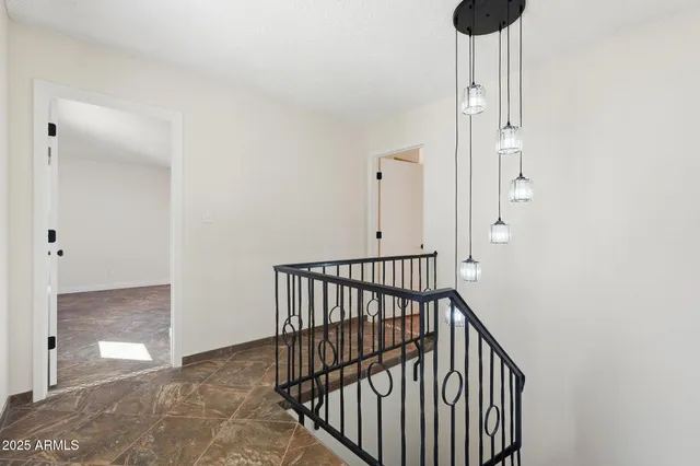 a view of a hallway with wooden floor and a window
