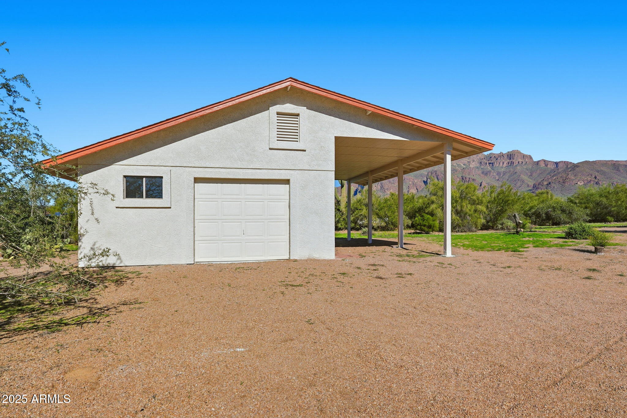 5810 East 14th Avenue Apache Junction, AZ 85119 - Photo 7 of 38 a view of a house with backyard and a garden
