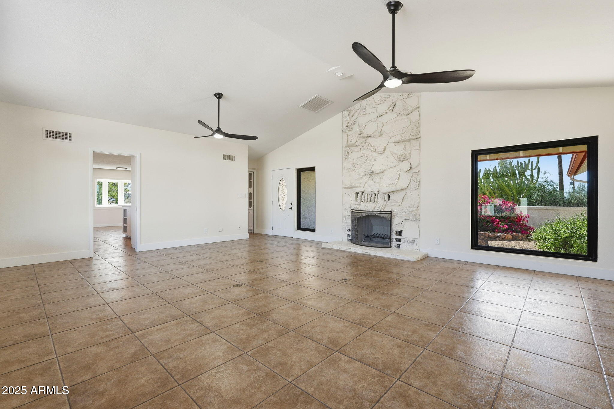 5810 East 14th Avenue Apache Junction, AZ 85119 - Photo 10 of 38 a view of an empty room with a fireplace and a window