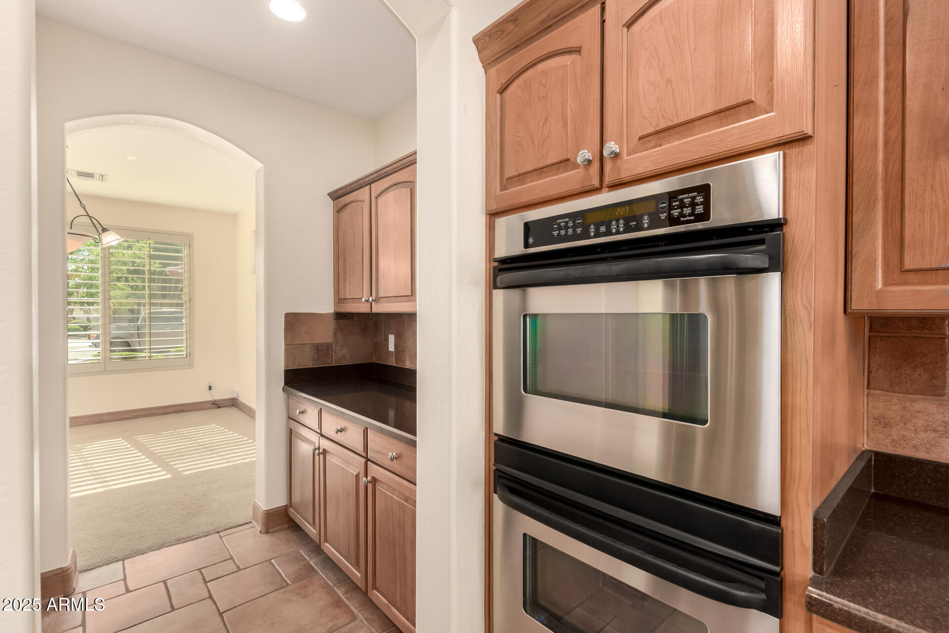 5902 West Gambit Trail Phoenix, AZ 85083 - Photo 43 of 62 a kitchen with granite countertop a stove and a microwave