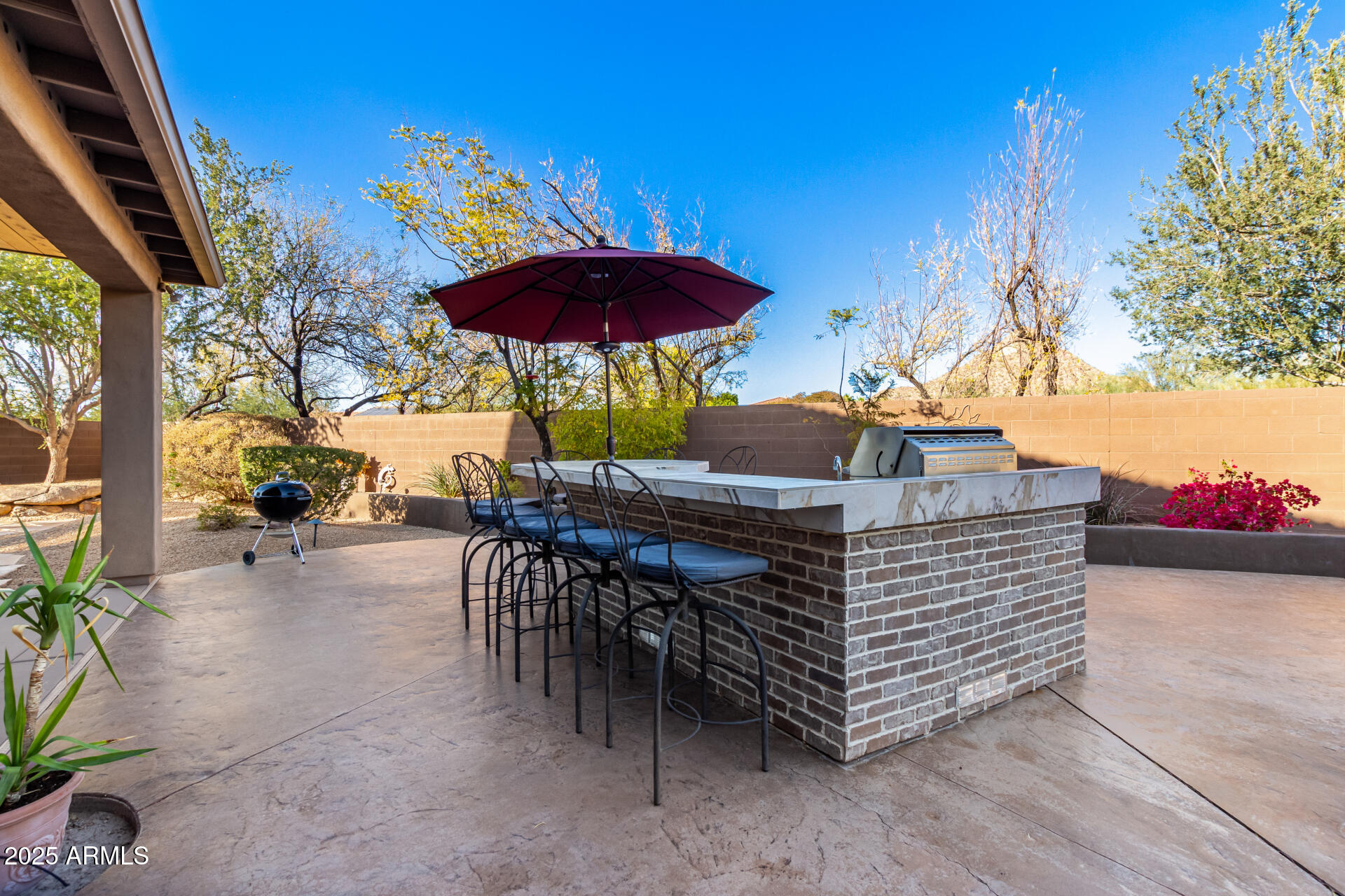 5902 West Gambit Trail Phoenix, AZ 85083 - Photo 51 of 62 a view of a patio with a table and chairs under an umbrella