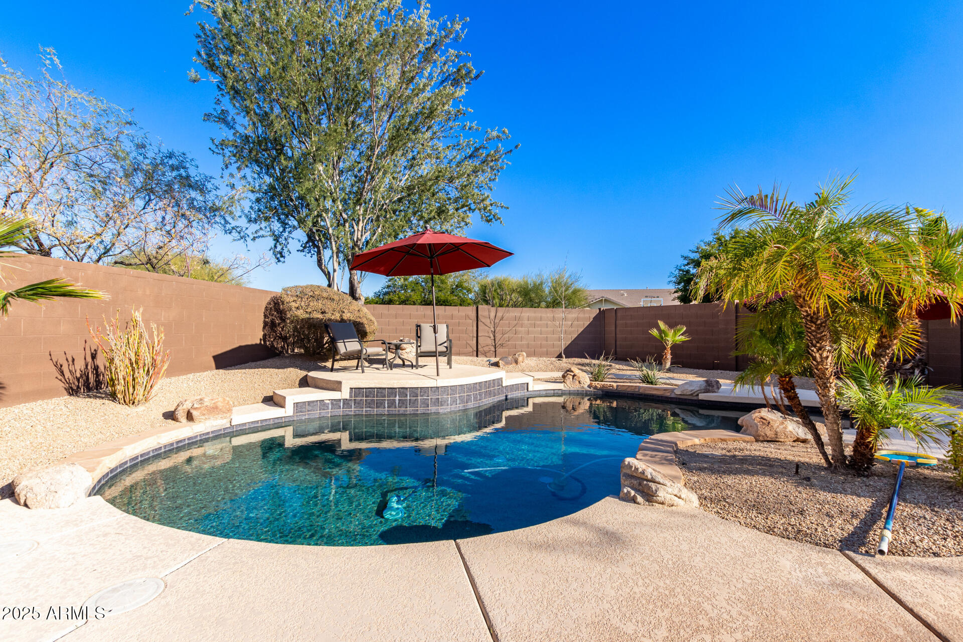 5902 West Gambit Trail Phoenix, AZ 85083 - Photo 55 of 62 a view of a backyard with couches chair under an umbrella