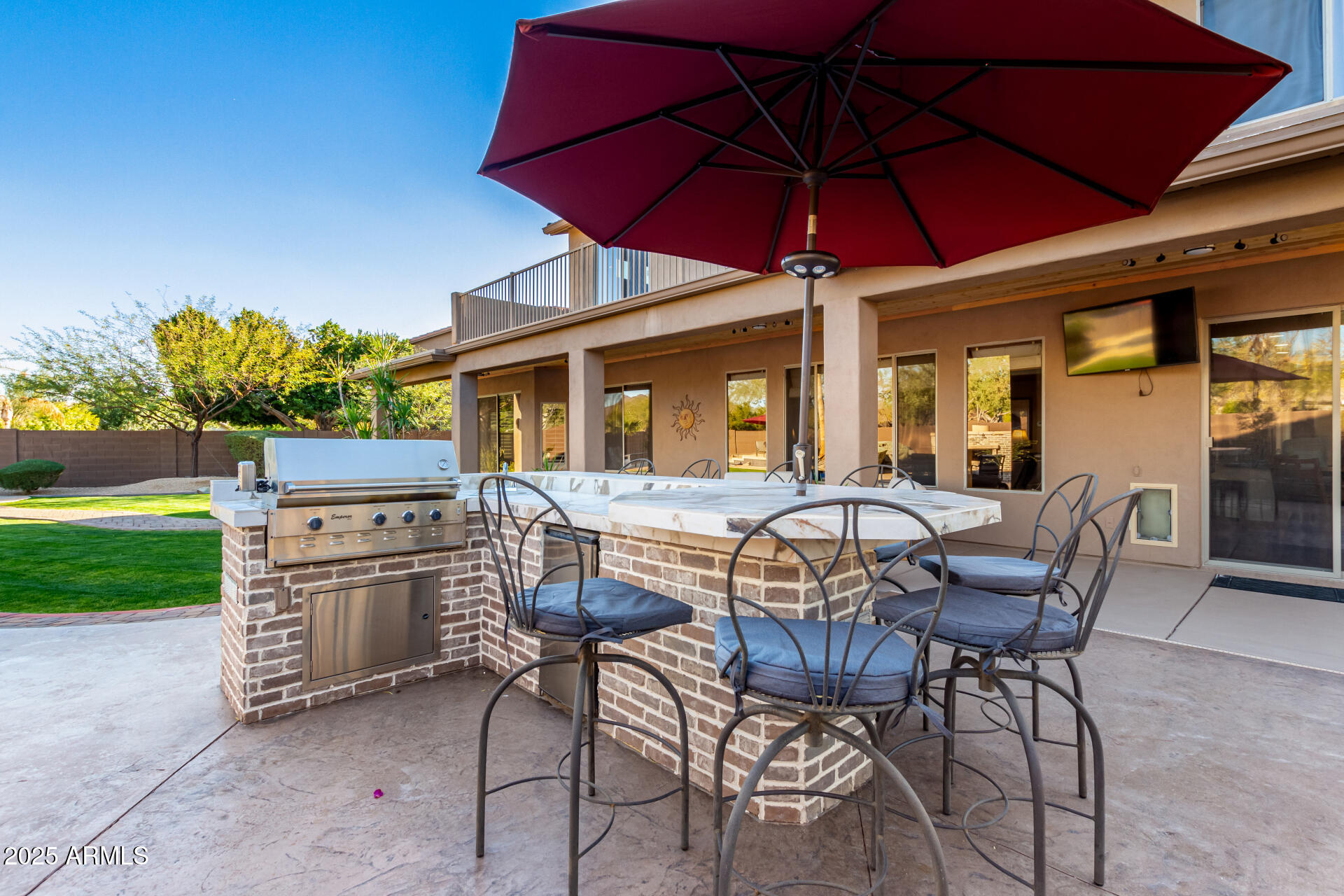 5902 West Gambit Trail Phoenix, AZ 85083 - Photo 10 of 62 a patio with a table and chairs under an umbrella