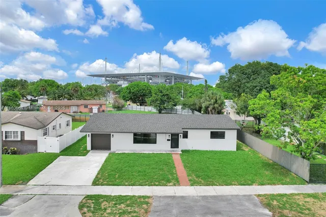 a aerial view of a house next to a yard