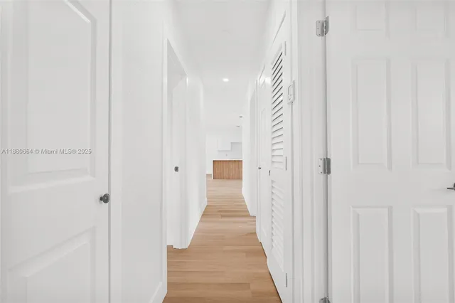 a view of a hallway with wooden floor