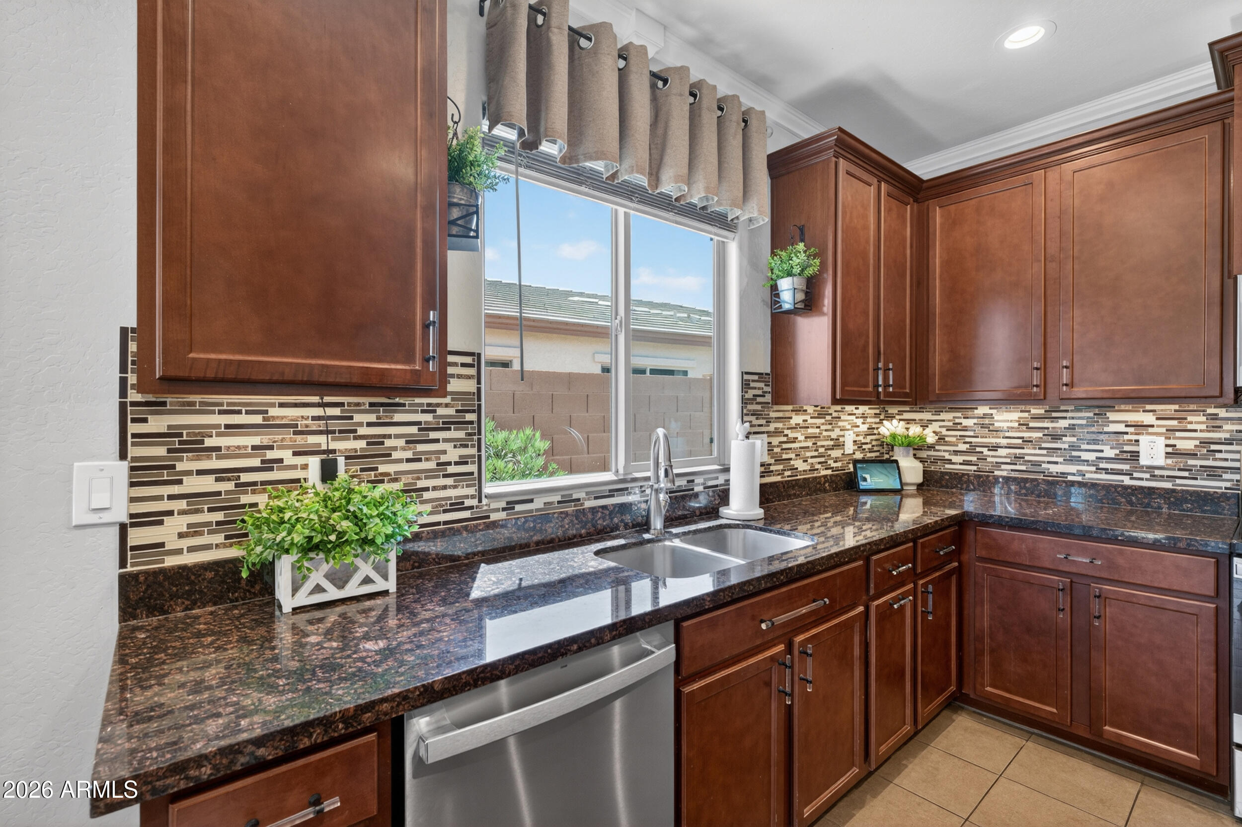 18612 West Mountain View Road Waddell, AZ 85355 - Photo 12 of 71 a kitchen with stainless steel appliances granite countertop a sink and a counter space