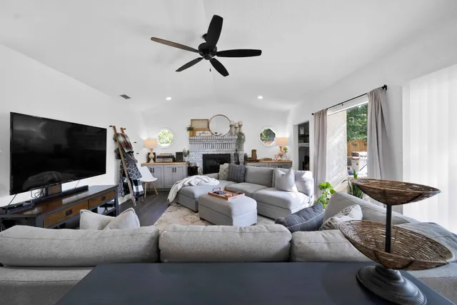 a living room with furniture white walls and wooden floor