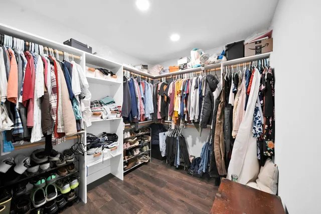 a bedroom with a bed and a ceiling fan