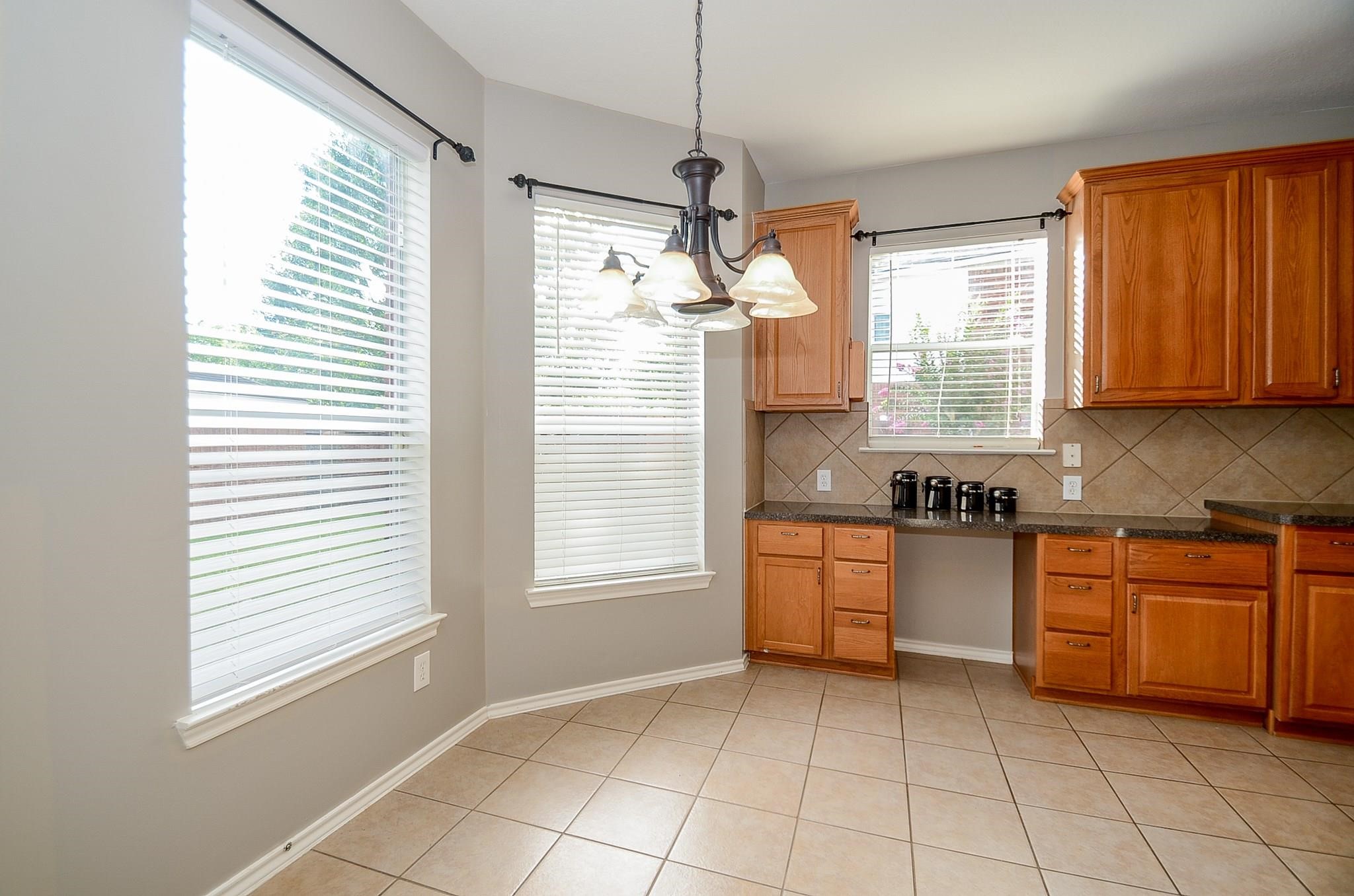 23719 Tustin Ranch Court Katy, TX 77494 - Photo 14 of 31 a kitchen with a window a sink and a stove