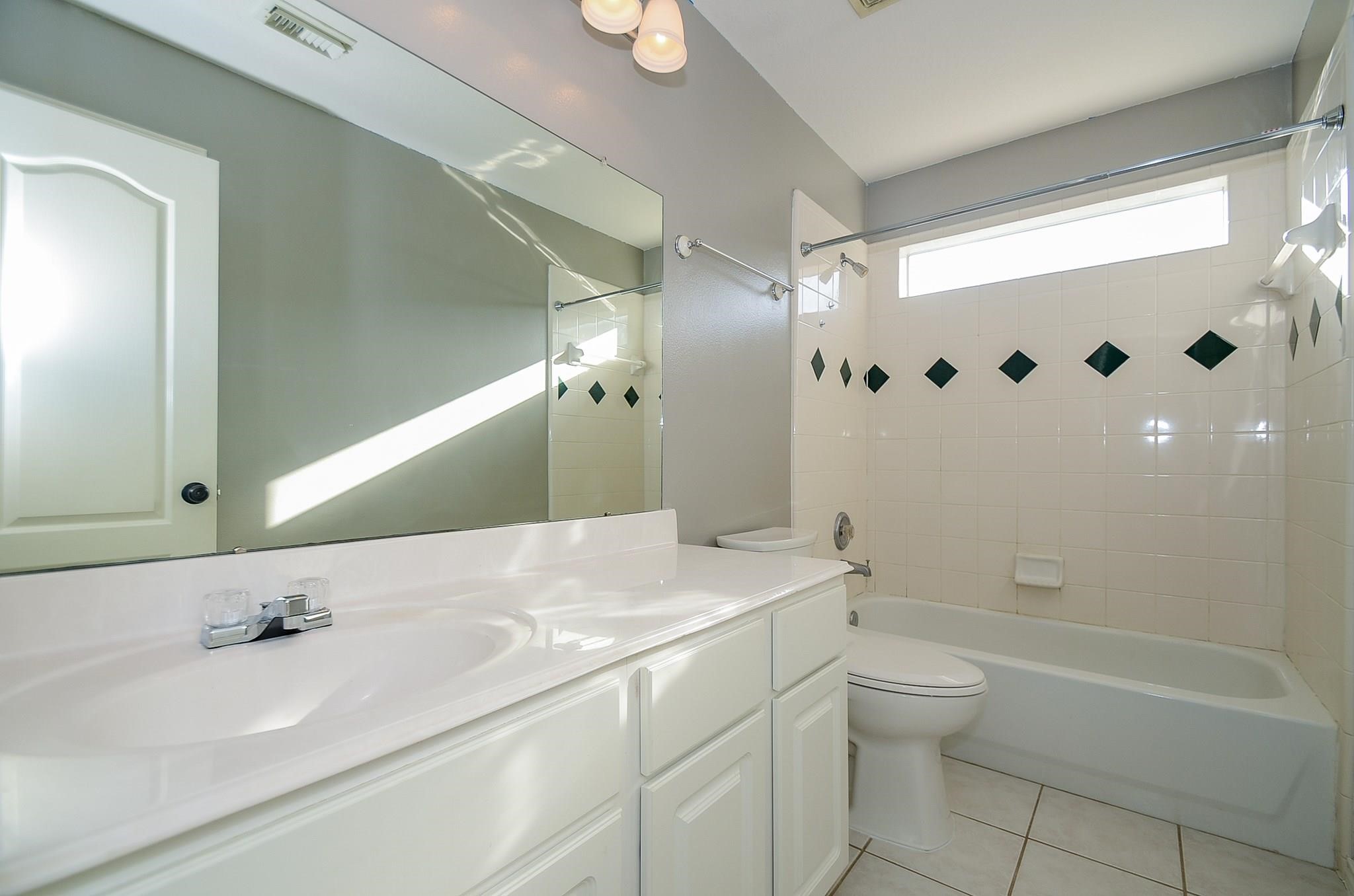 23719 Tustin Ranch Court Katy, TX 77494 - Photo 20 of 31 a bathroom with a granite countertop bathtub sink vanity mirror and toilet