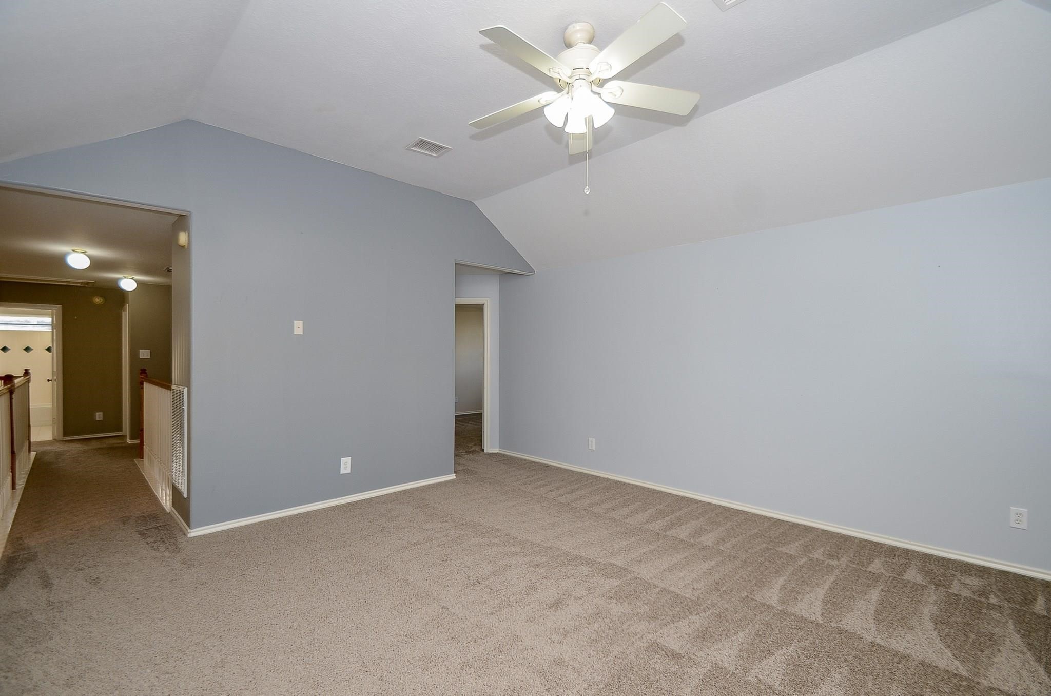 23719 Tustin Ranch Court Katy, TX 77494 - Photo 23 of 31 an empty room with chandelier fan